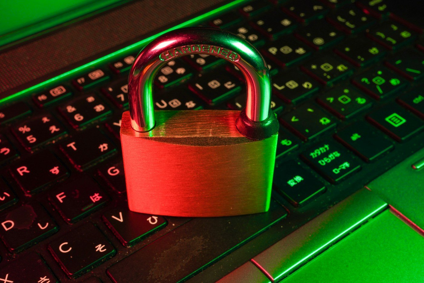 Red padlock on a black keyboard representing cybersecurity